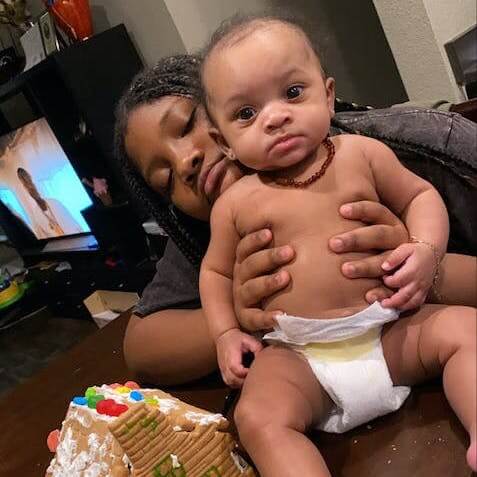 African American Mom Holding Her Four Months Baby Boy Who is Wearing Baltic Amber Teething Necklace in Cognac Color with Polished Beads from Amber Guru