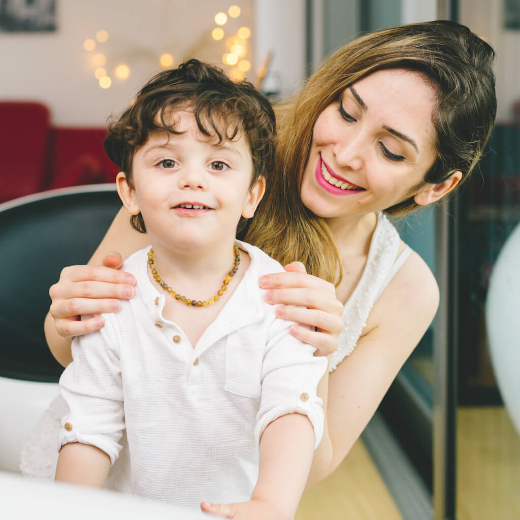 2 Years Old Boy Wearing The Rare Green Unpolished Baltic Amber Necklace for Children from Amber Guru