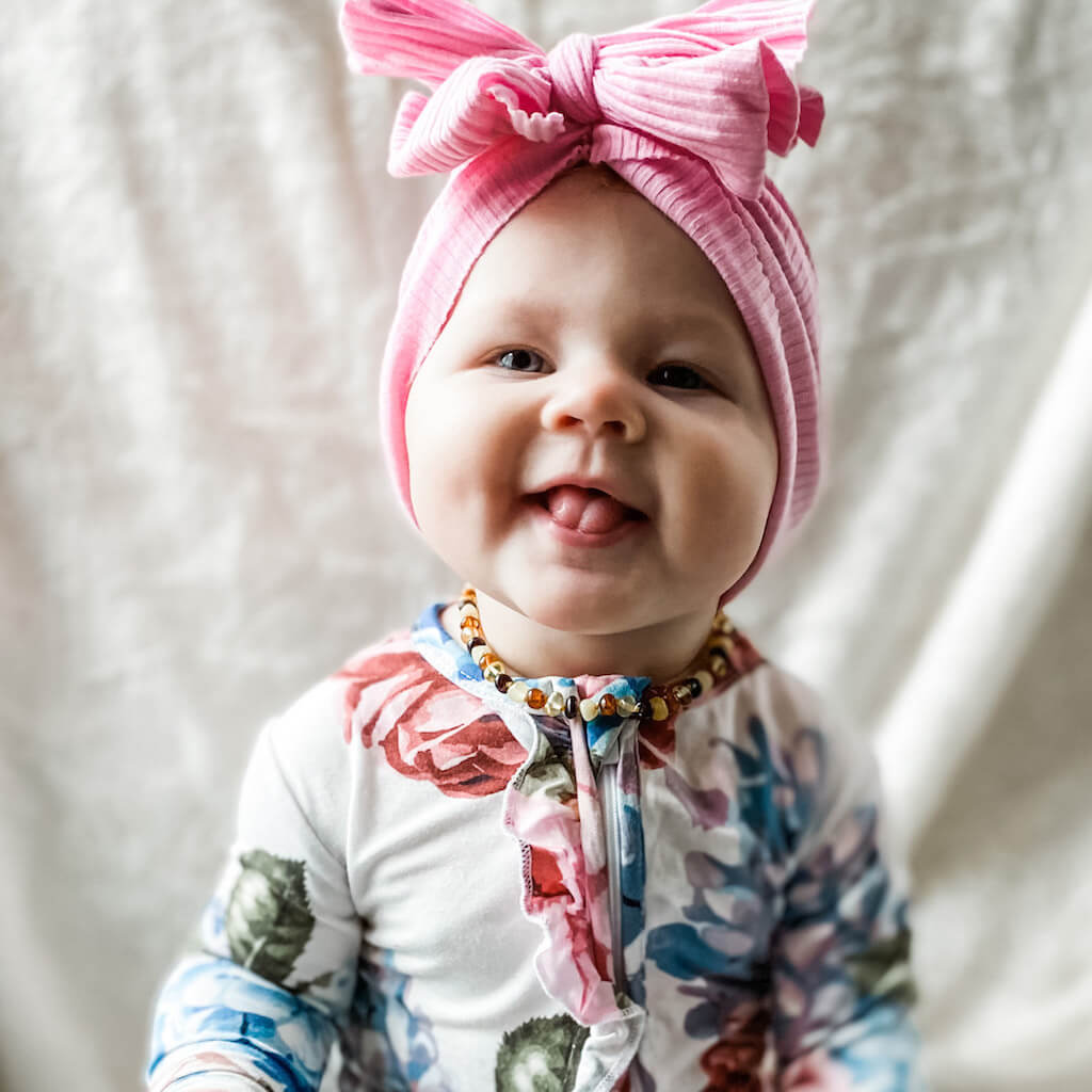 Happy Baby Girl With Multi Colored Polished Amber Teething Necklace Handmade by Amber Guru