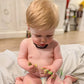 Blond Baby Boy Wearing Raw Black Baltic Amber Teething Necklace from Amber Guru, Sitting in the Room